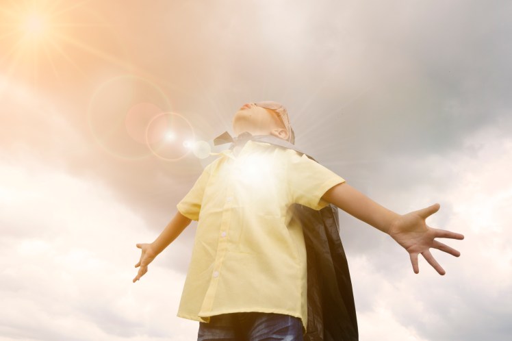 happy kid play superhero , boy power concept